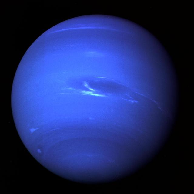 Neptune as captured by Voyager 2, showing the planet's vivid blue atmosphere and wispy white clouds